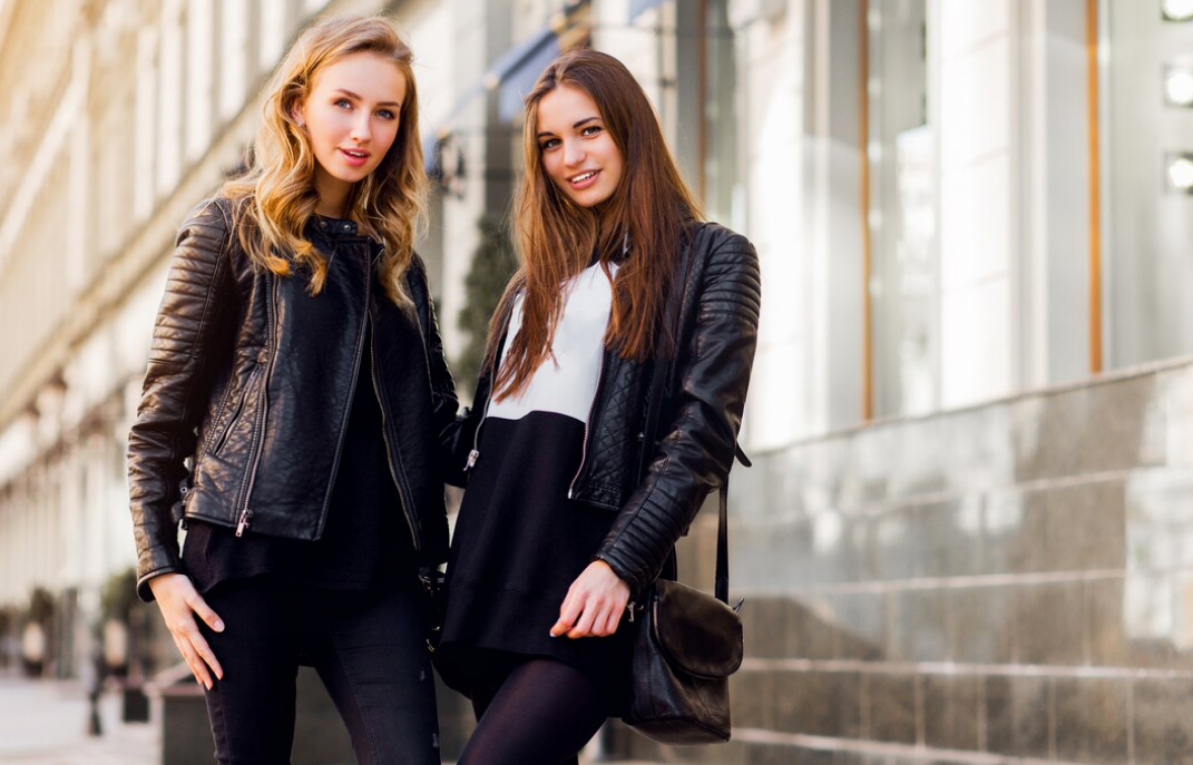 two women wearing leather jacket in sunny weather